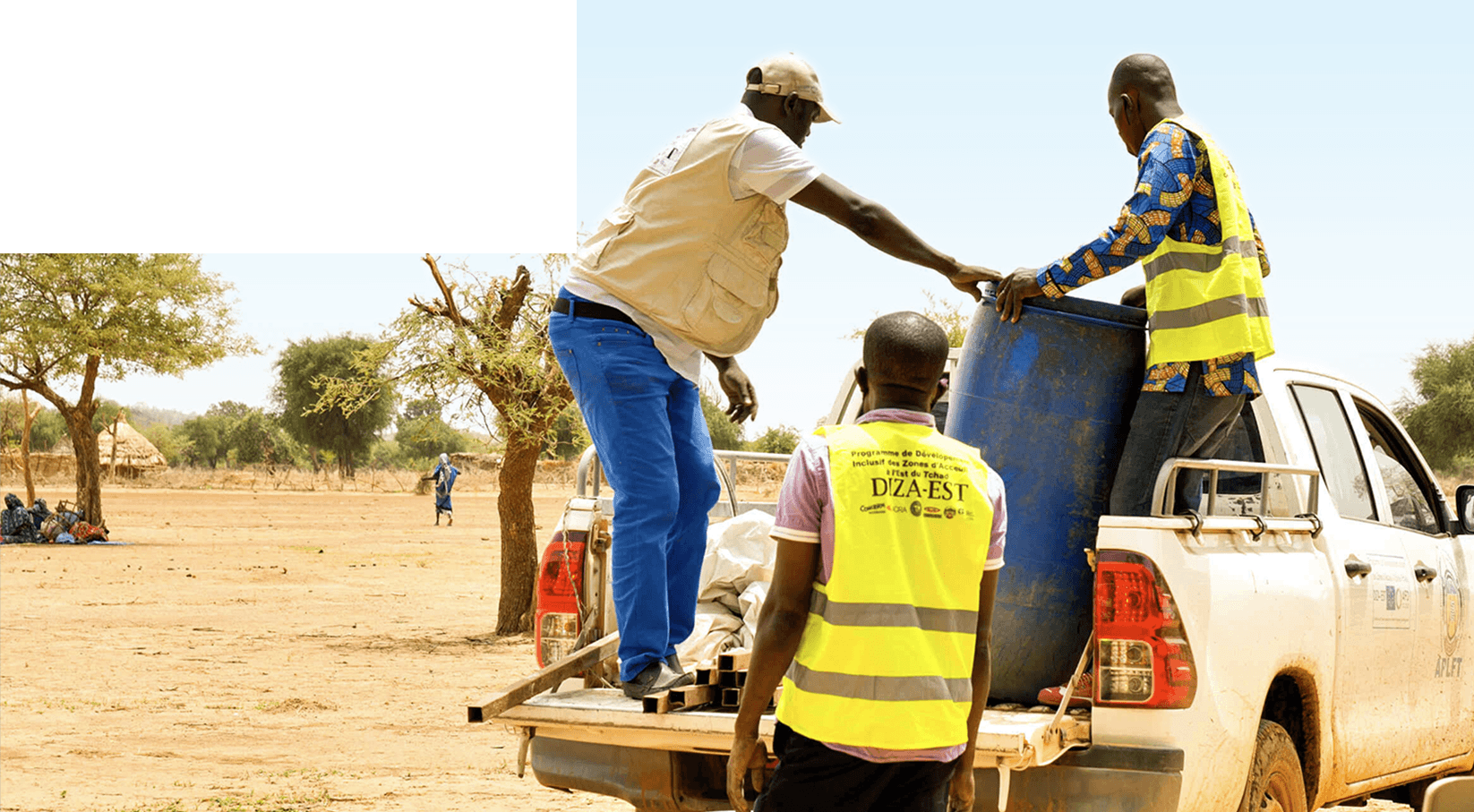 Men wearing Diza-Est tunics loading a vehicle